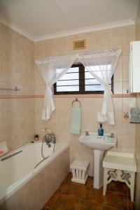a bathroom with a bath tub and a sink at Sea View townhouse in Zinkwazi Beach in Zinkwazi Beach