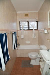 a bathroom with a tub and a toilet and a sink at Sea View townhouse in Zinkwazi Beach in Zinkwazi Beach