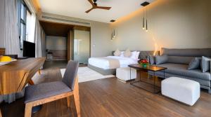 Habitación de hotel con cama y sala de estar. en Aria Resort & Spa - Pure Veg, en Nashik