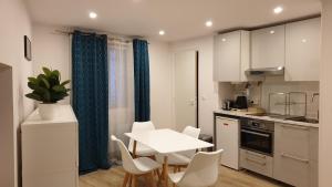 a kitchen with a table and chairs in a kitchen at Alex Place's in Saint-Ouen-lʼAumône