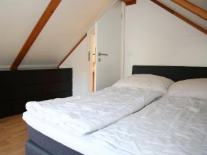 ein großes weißes Bett in einem Zimmer mit Fenster in der Unterkunft Haus Janina in Rieste