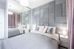 Säng eller sängar i ett rum på Manufaktura SKYLINE by PinPoint