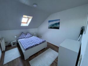 a small bedroom with a bed and a window at Ferienwohnung Lappano - Losheim am See in Bachem