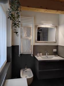 a bathroom with a sink and a toilet and a mirror at Le Farfalle di Armeno in Armeno +33 photos