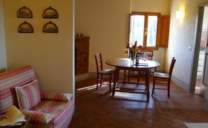 a living room with a table and a couch at Suite La Pieve Villa Le Barone Panzano in Chianti in Panzano