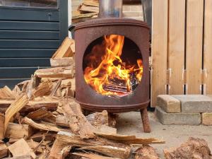 a wood stove with a fire in it at Studio "Shoshana" Harderwijk in Harderwijk