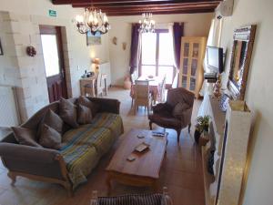 a living room with a couch and a table at Villa Petra in Kalyves