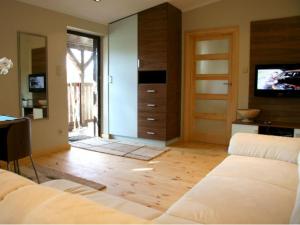 a living room with a couch and a tv at Apartamenty w Ustce in Ustka