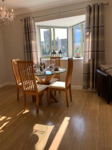 a dining room with a table and chairs and a window at Mill Pond View in Pembroke