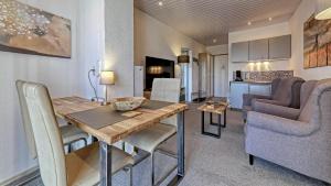 a kitchen and living room with a table and chairs at Suit' & Frühstück Zum Latschen - Adults Only in Mauth