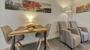 a meeting room with chairs and a table with a lamp at Suit' & Frühstück Zum Latschen - Adults Only in Mauth +92 photos