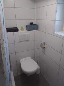a white bathroom with a toilet and a window at Ferienwohnung Jansen "Zwei" in Bad Schwalbach +20 photos