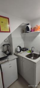 a small kitchen with a sink and a counter at Yair room apartment in Jerusalem