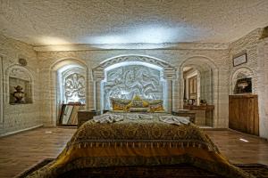 a bedroom with a large bed in a building at Kayatas Cave Suites in Göreme