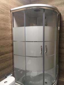 a glass shower in a bathroom with a toilet at ESENIN-LocuS in Novosibirsk