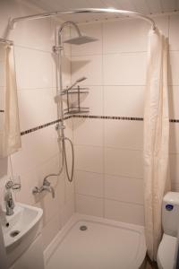 a bathroom with a shower and a toilet and a sink at Mia Kiviõli Apartment in Kiviõli