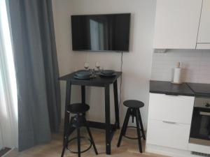 a small table in a kitchen with two stools at Lutakko Apartment 2 with free car parking in Jyväskylä