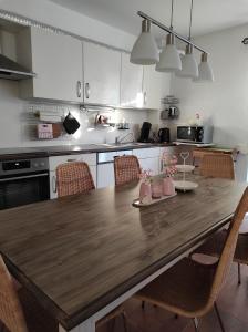 a kitchen with a wooden table and chairs at Ferienwohnung Sonnenlicht in Kappel-Grafenhausen