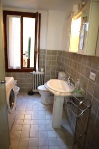 a bathroom with a sink and a toilet and a window at VENICE RAINBOW APARTMENT (RIALTO) in Venice