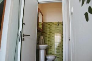 a bathroom with a sink and a toilet at Roots Apartment in Zambujeira do Mar