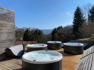 a jacuzzi tub on a wooden deck at Bed & Wellness Fisterre in Belluno