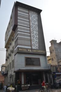 a person riding a bike in front of a building at Hotel KK Continental 50 Meter from Railway Station - Amritsar in Amritsar