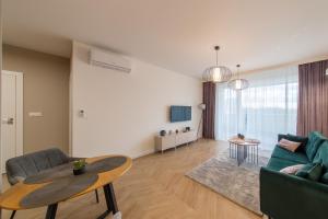 Televízia a/alebo spoločenská miestnosť v ubytovaní VIP Apartamenty Butikowa