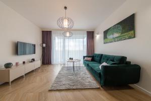 Televízia a/alebo spoločenská miestnosť v ubytovaní VIP Apartamenty Butikowa