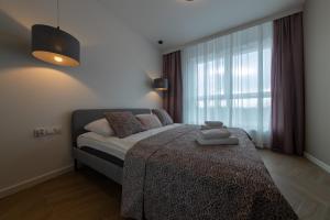 Posteľ alebo postele v izbe v ubytovaní VIP Apartamenty Butikowa
