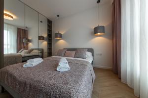 Posteľ alebo postele v izbe v ubytovaní VIP Apartamenty Butikowa