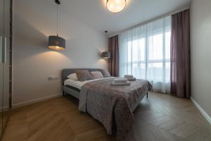 Posteľ alebo postele v izbe v ubytovaní VIP Apartamenty Butikowa