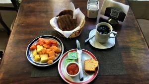 a table with two plates of food and a cup of coffee at Hotel Santa Ana in Mérida