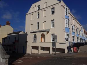 a large white building on the side of a street at Valentine Guest House in Weymouth