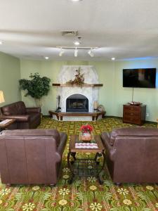 a living room with two couches and a fireplace at Brookwood Inn Branson in Branson