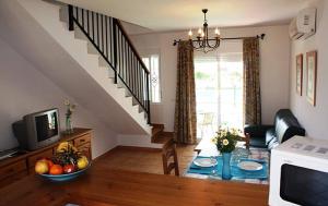 a living room with a table with a bowl of fruit at Apartamentos Los Olivos in Conil de la Frontera