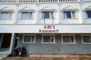 a motorcycle parked in front of a building at ABI`S RESIDENCY in Thanjāvūr +9 photos