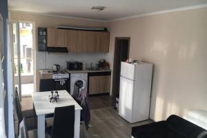 a kitchen with a white refrigerator and a table at VIP VISION - 214 entire flat 2 beds two baths in Sunny Beach