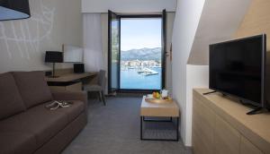 a living room filled with furniture and a tv at Aminess Liburna Hotel in Korčula