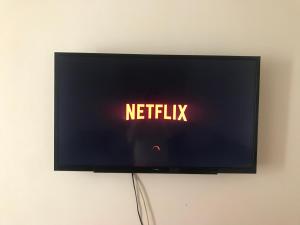a television screen with the words netflix on it at Love House Tanger in Tangier