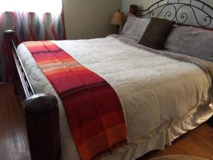 a bed with a colorful blanket on top of it at Short North/OSU Pet Friendly! in Columbus