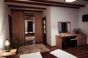 a living room with a door leading to a bedroom at Pensiunea Casa Lupas in Gilău