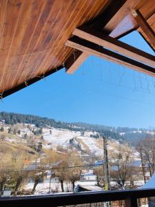 a view of a snow covered field from a roof at Pensiunea Bucur in Dămuc