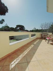 a patio with chairs and a window on a wall at Sxinias Resort in Marathón