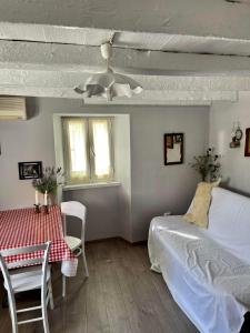 a bedroom with a bed and a table and chairs at Lubenice-Rodinis Room and Apartment in Lubenice