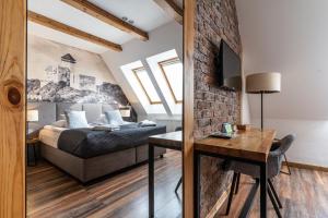 a bedroom with a bed and a table in a room at Boutique Penzion Slovakia & Slovakia Residence in Košice