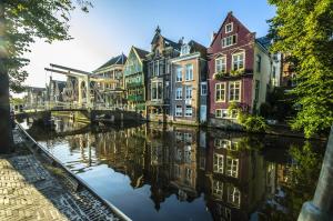 a group of buildings next to a river at Appartement Schoorl in Schoorl