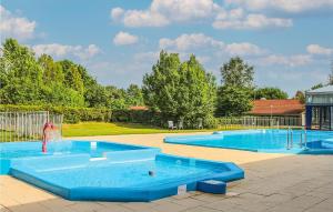 a large swimming pool with a water fountain in it at 3 Bedroom Stunning Home In Gramsbergen in Gramsbergen