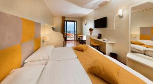 Postel nebo postele na pokoji v ubytování Hotel Residence Villa Beatrice