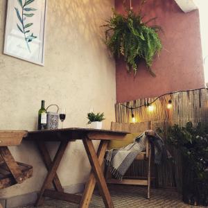 a wooden table with a glass of wine on it at Departamento Rinconcito olivo, 5min centro, home office in Valle de Bravo