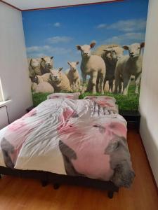 a bedroom with a painting of a herd of sheep at Aan 't weitje in Ermelo